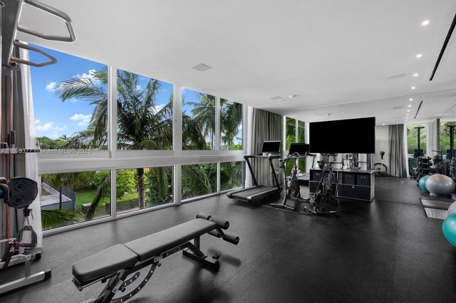 a view of a room with gym equipment and windows