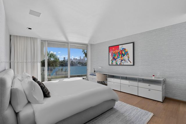 a bedroom with a bed and a large window