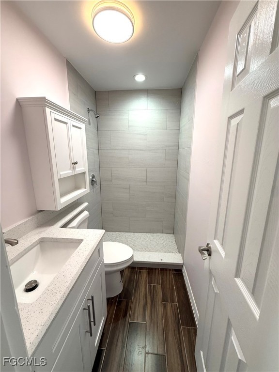 34 Hamlin Court Lehigh Acres, FL 33936 - Photo 5 of 11 a bathroom with a sink a toilet and shower