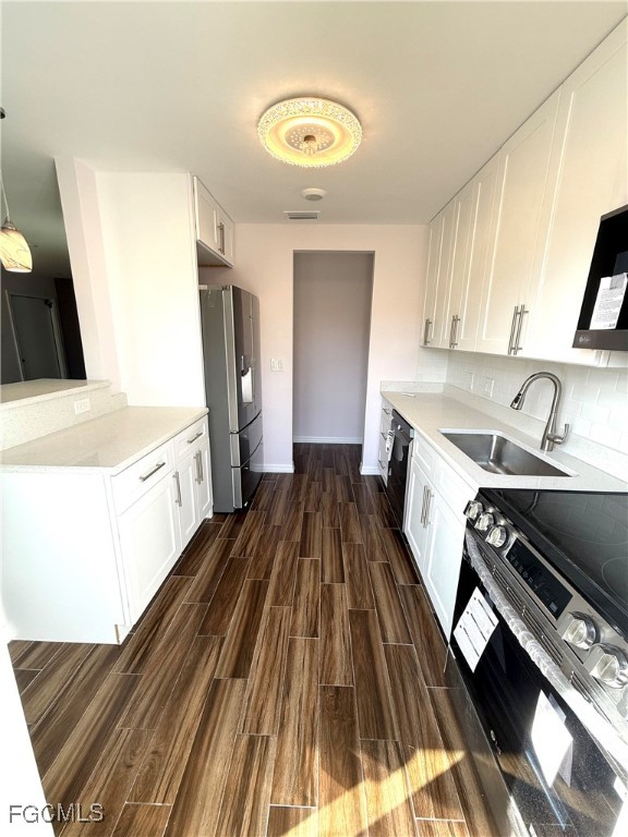 34 Hamlin Court Lehigh Acres, FL 33936 - Photo 8 of 11 a kitchen with a sink stove and refrigerator