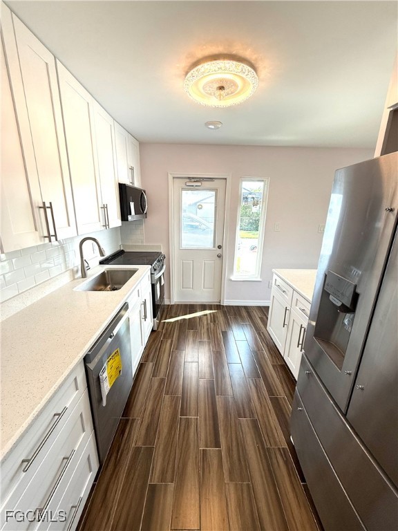 34 Hamlin Court Lehigh Acres, FL 33936 - Photo 9 of 11 a kitchen with sink cabinets and wooden floor