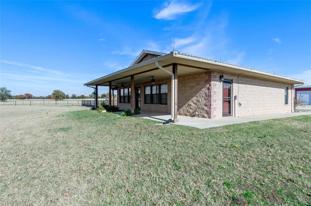 395 Yacht Club Road Oak Point, TX 75068 - Photo 16 of 23 Rear view of house with covered porch, a ceiling fan, and concrete block siding