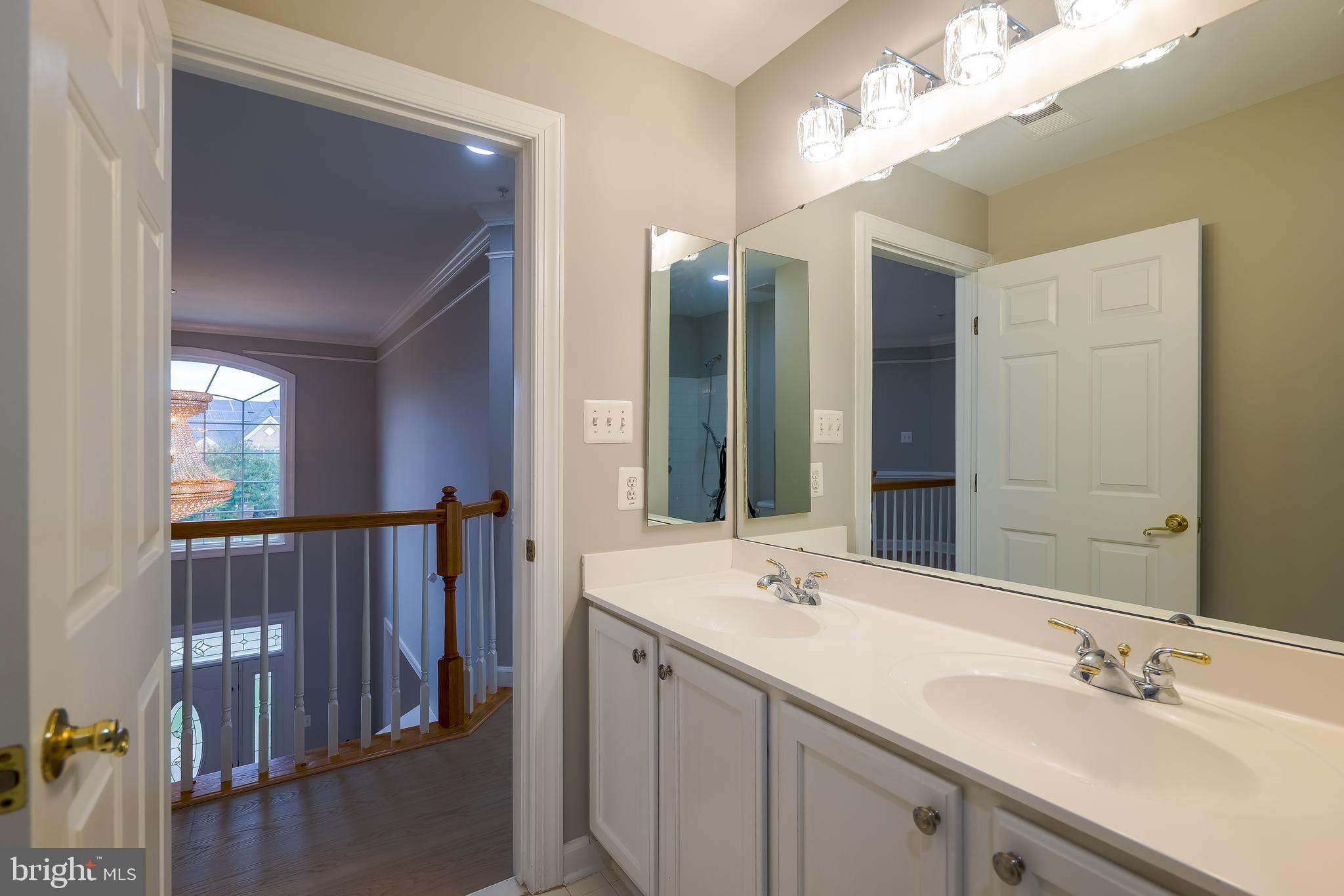 7709 Killbarron Drive Laurel, MD 20707 - Photo 11 of 79 a bathroom with a double vanity sink and a mirror