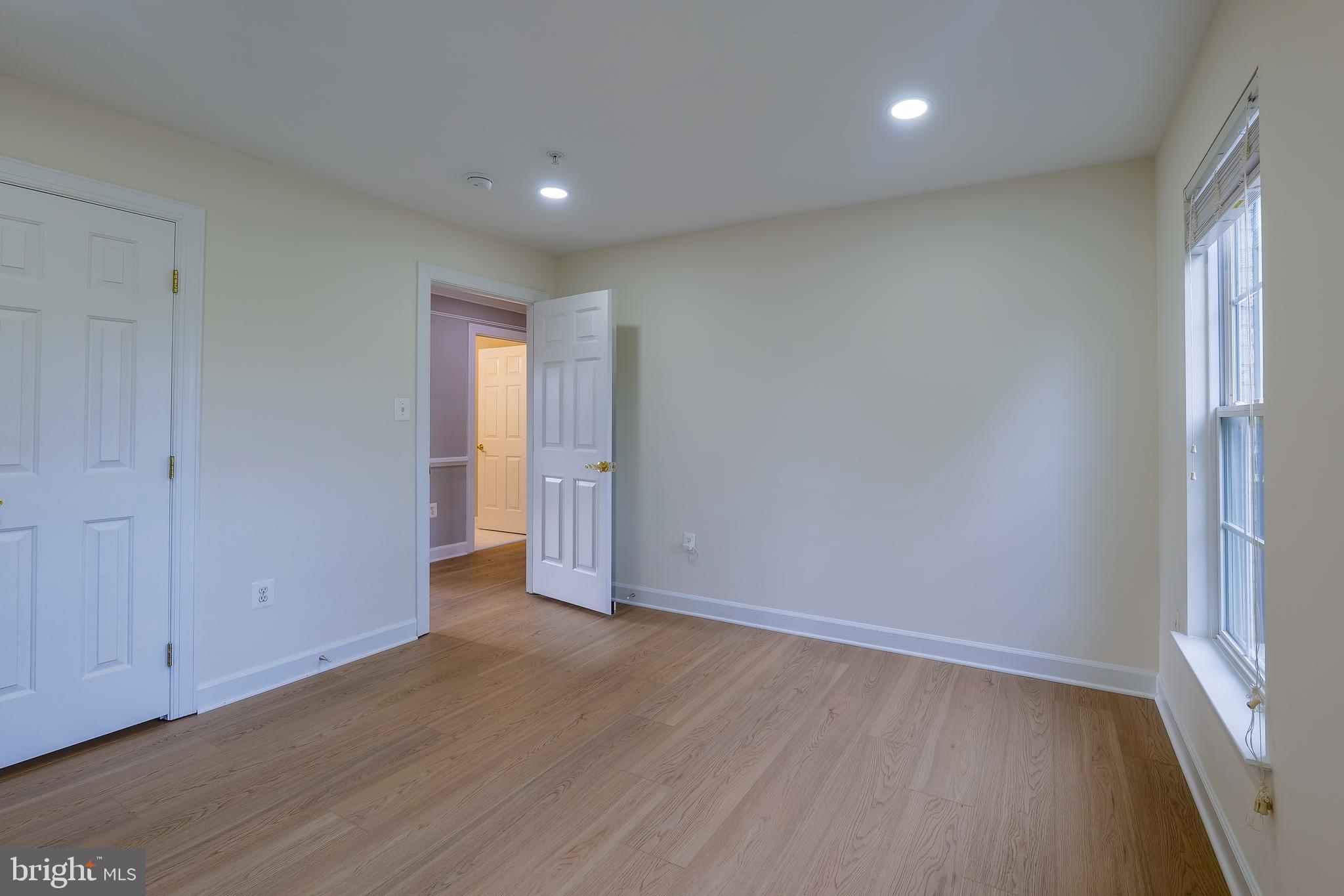 7709 Killbarron Drive Laurel, MD 20707 - Photo 14 of 79 wooden floor in an empty room with a window