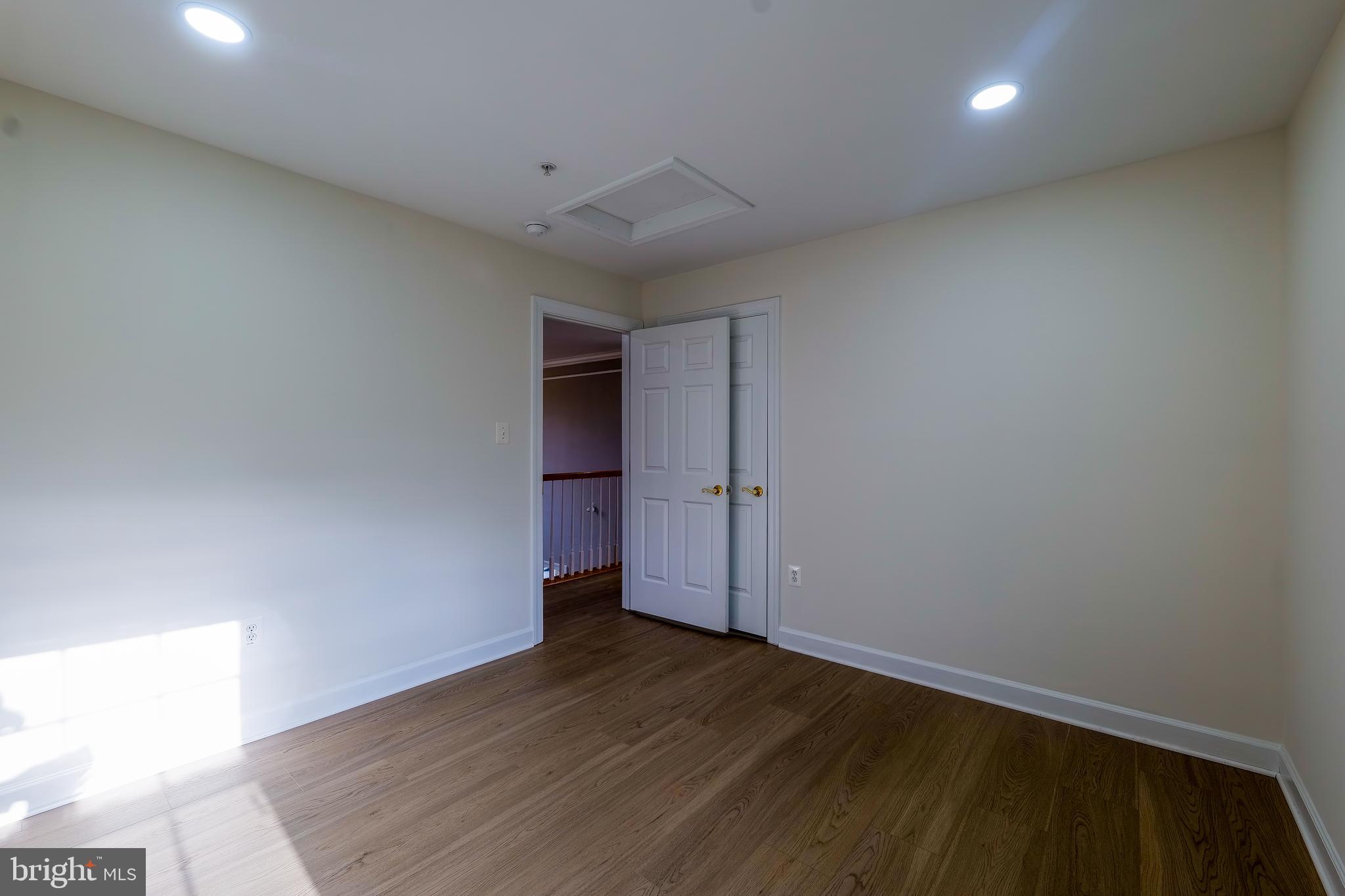 7709 Killbarron Drive Laurel, MD 20707 - Photo 20 of 79 an empty room with wooden floor and windows