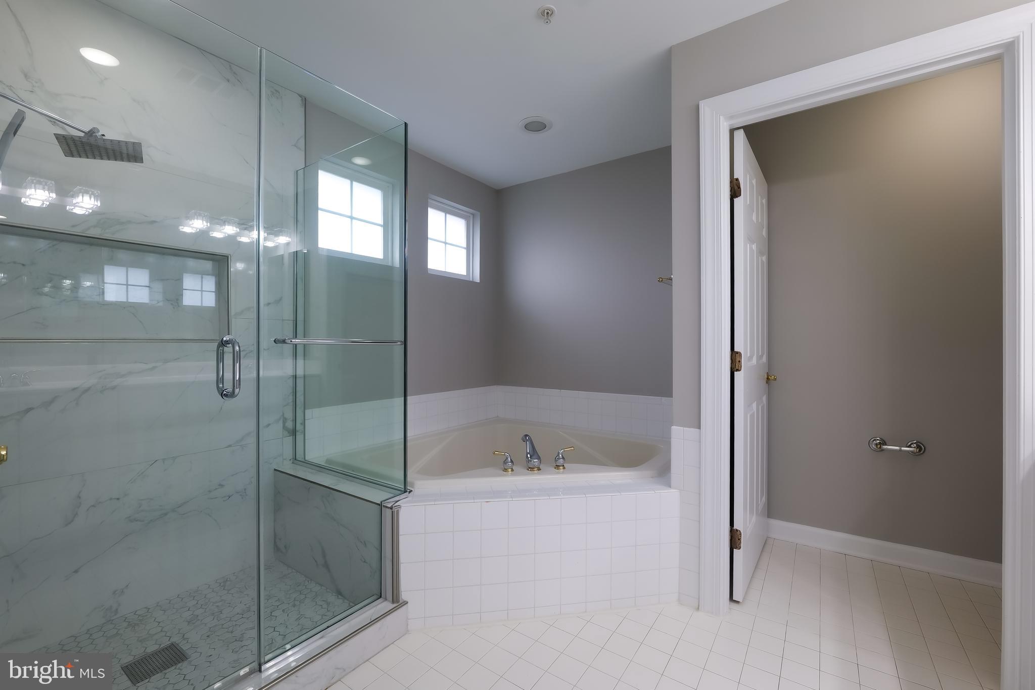 7709 Killbarron Drive Laurel, MD 20707 - Photo 27 of 79 a bathroom with a bathtub and a shower