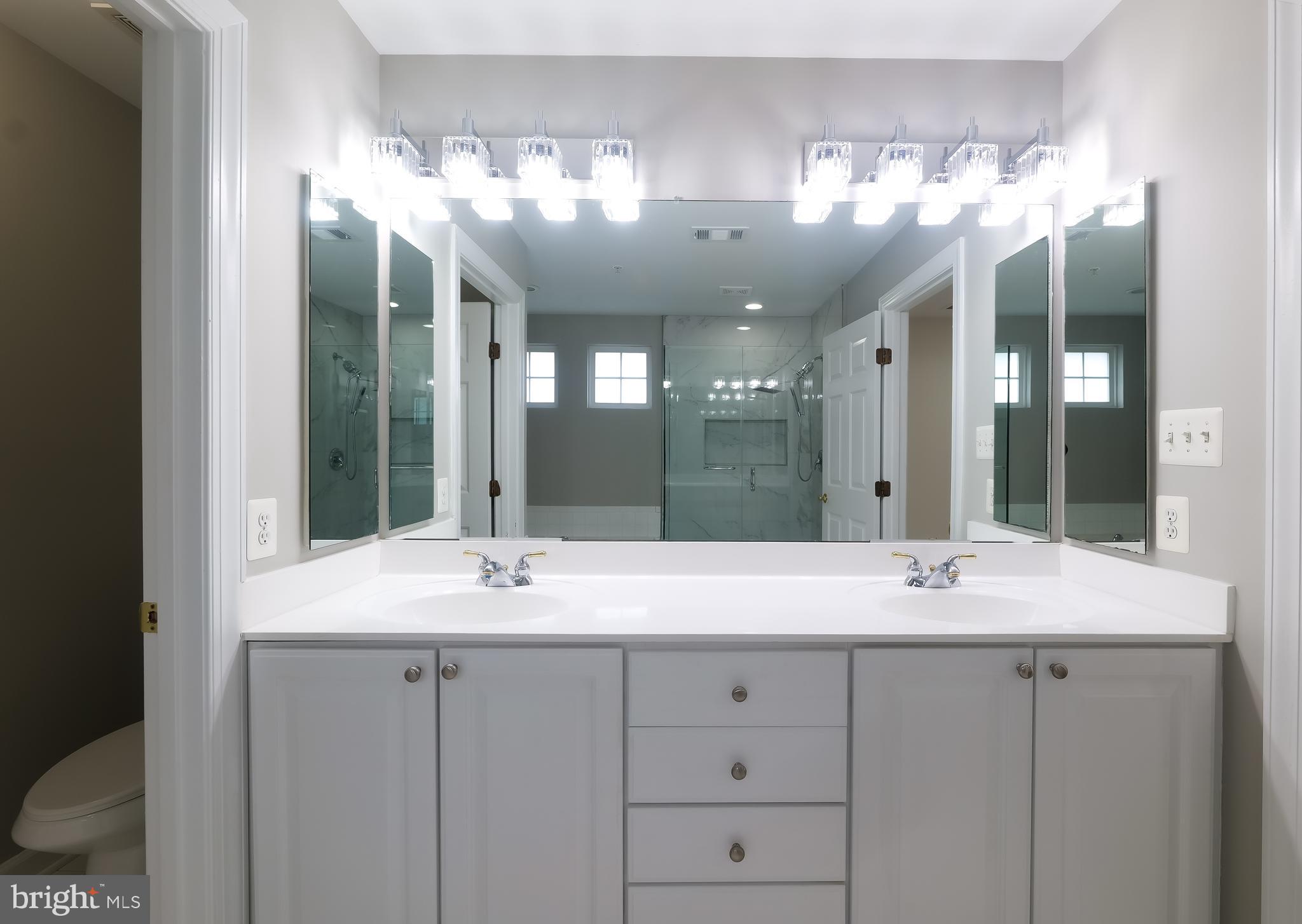 7709 Killbarron Drive Laurel, MD 20707 - Photo 29 of 79 a bathroom with a sink and a mirror