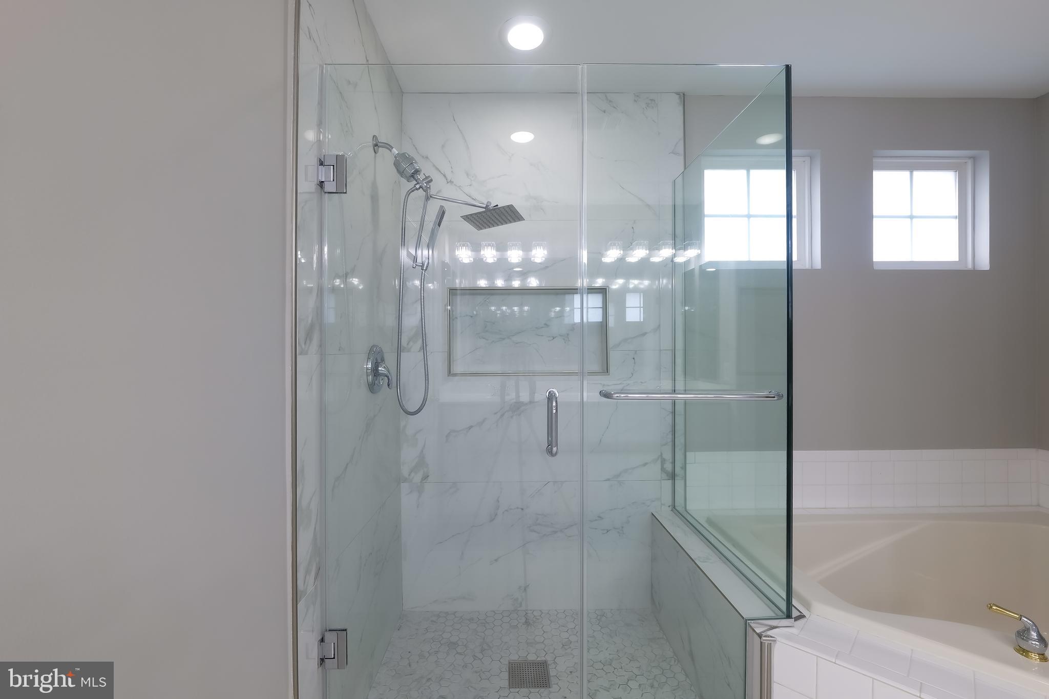 7709 Killbarron Drive Laurel, MD 20707 - Photo 30 of 79 a bathroom with a glass shower door