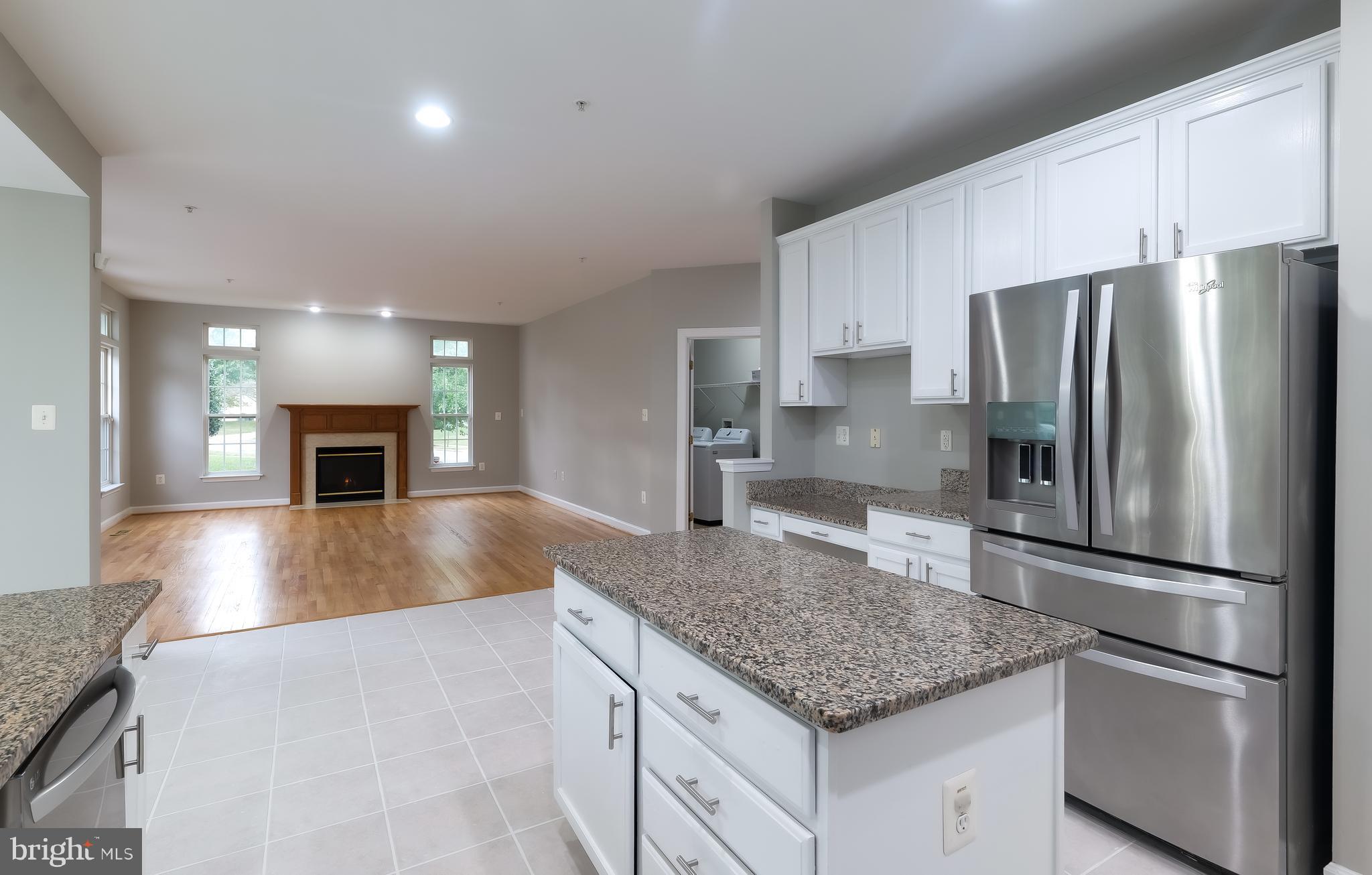 7709 Killbarron Drive Laurel, MD 20707 - Photo 51 of 79 a kitchen with stainless steel appliances granite countertop a refrigerator a stove a sink and a microwave
