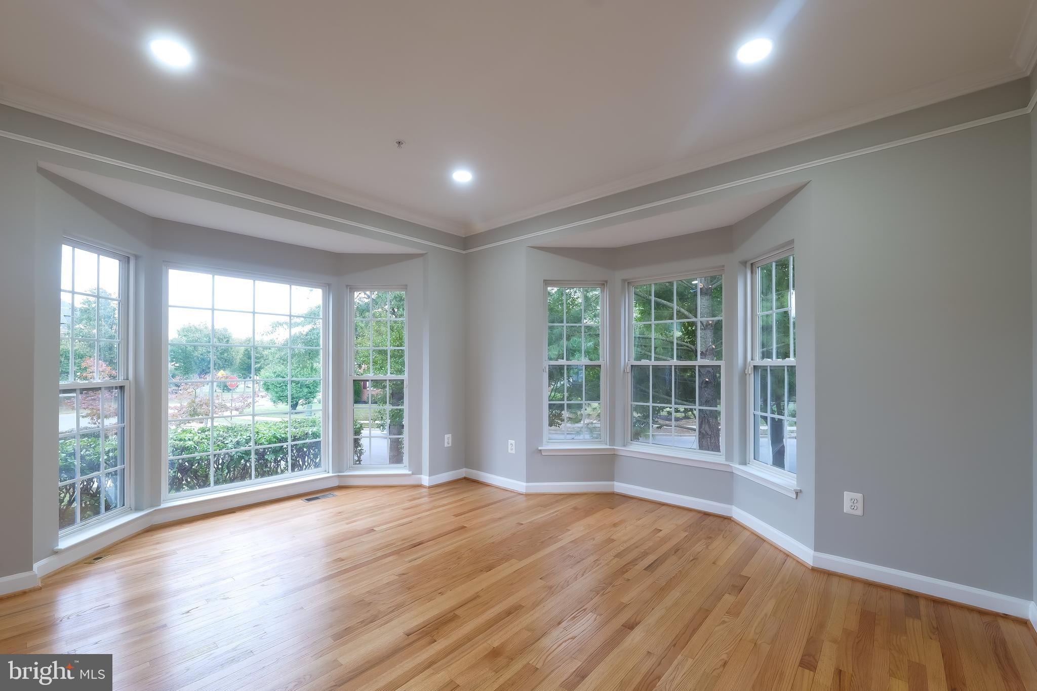 7709 Killbarron Drive Laurel, MD 20707 - Photo 59 of 79 a view of empty room with wooden floor and fan