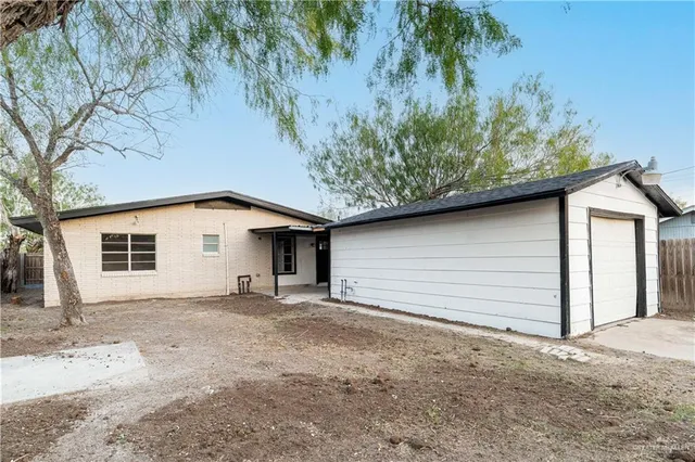 a backyard of a house with plants and trees