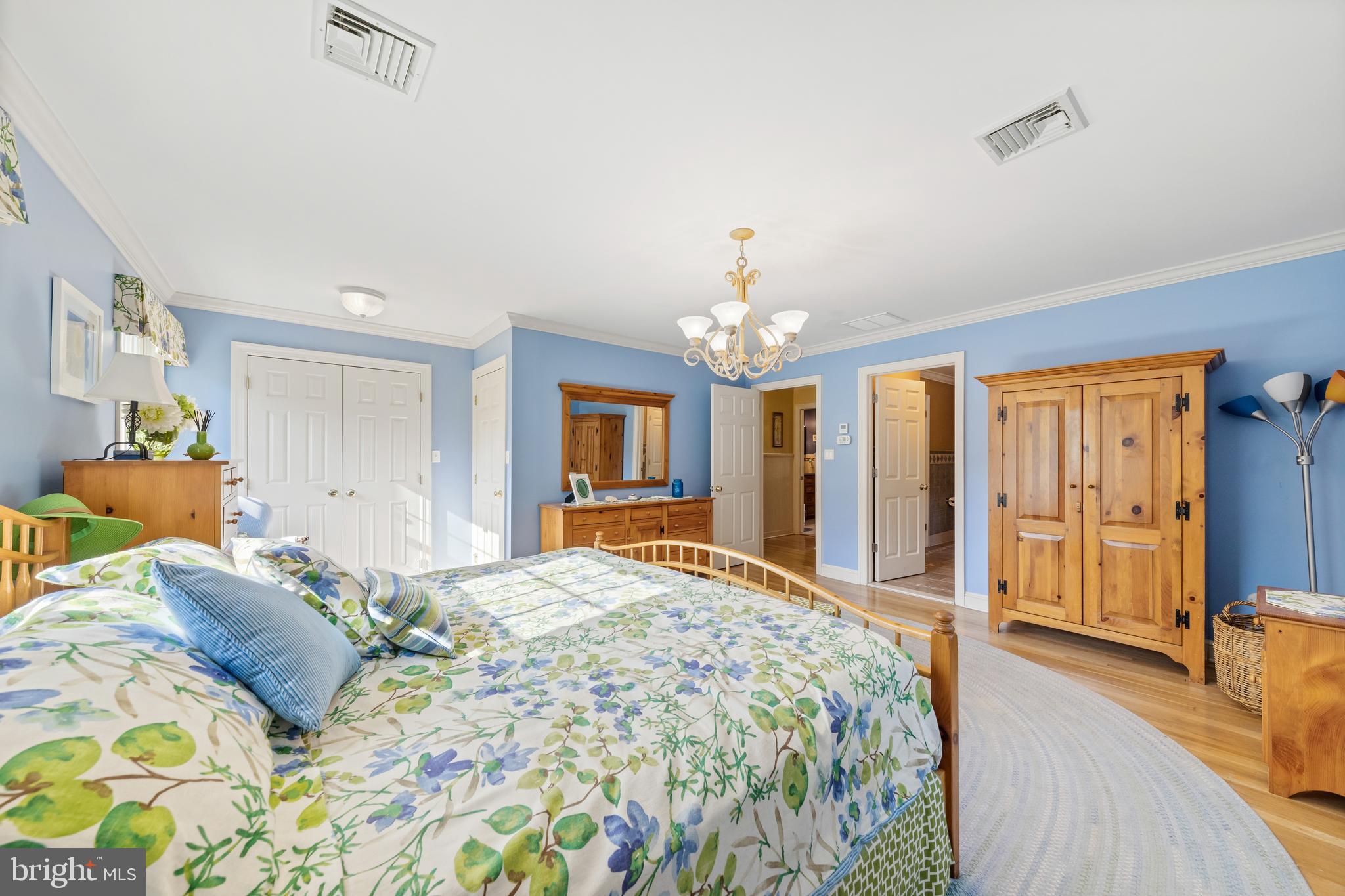 178 Lindbergh Road Hopewell, NJ 08525 - Photo 19 of 39 a bedroom with a large bed and a chandelier