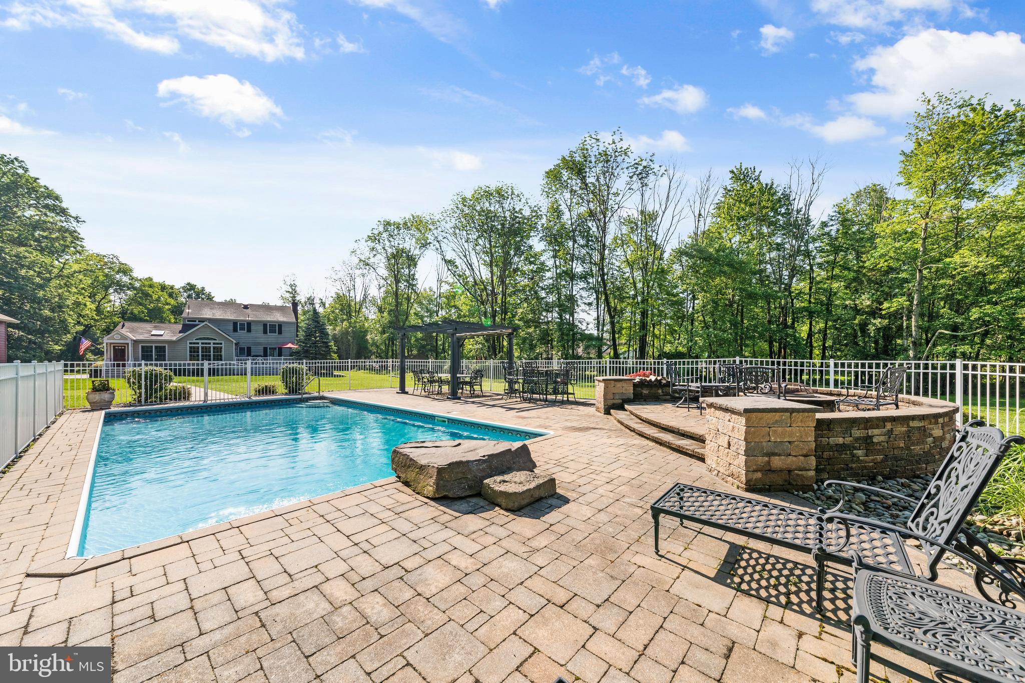 178 Lindbergh Road Hopewell, NJ 08525 - Photo 4 of 39 a view of a swimming pool with a lounge chair
