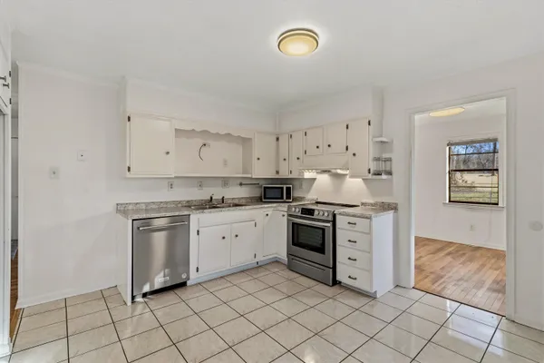 a kitchen with granite countertop cabinets and steel stainless steel appliances