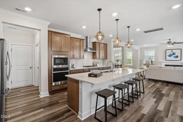 a kitchen with stainless steel appliances granite countertop a refrigerator sink and stove