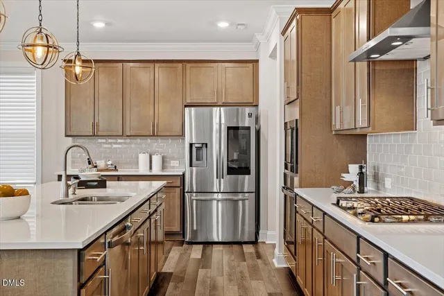 a view of a hallway with wooden floor and a bathroom