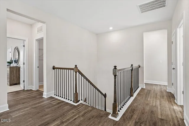a living room with furniture a flat screen tv and a window