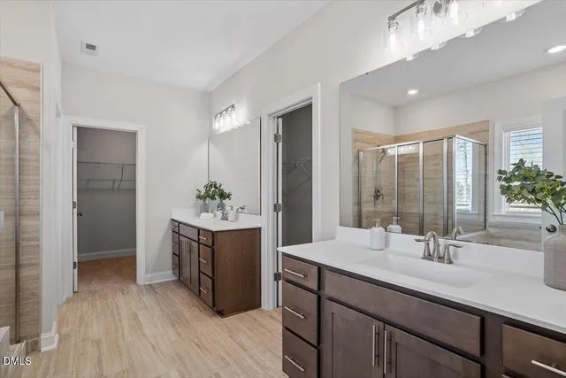 a bathroom with a sink double vanity and a mirror