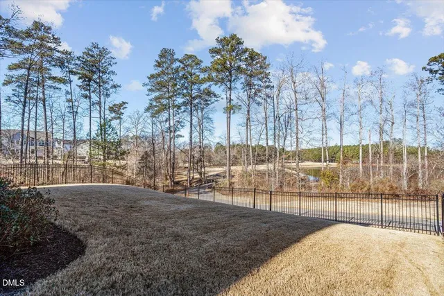 a view of a white house with a swimming pool yard and outdoor seating