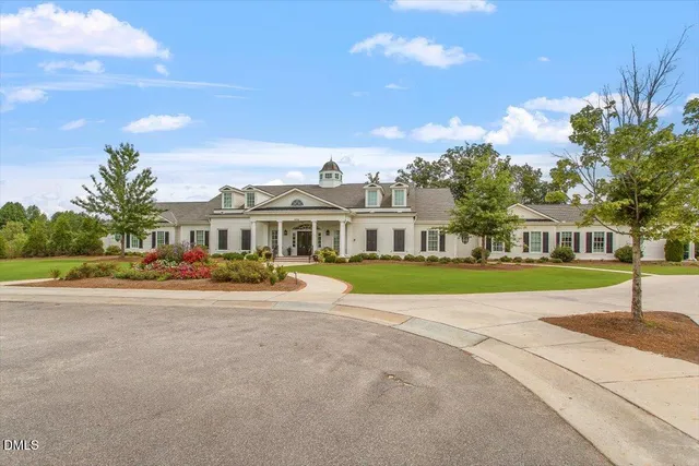 a view of a big yard with large trees