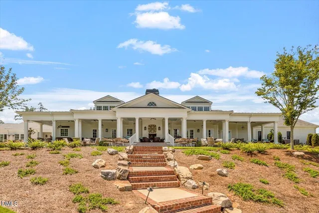 a view of backyard with seating space and trees