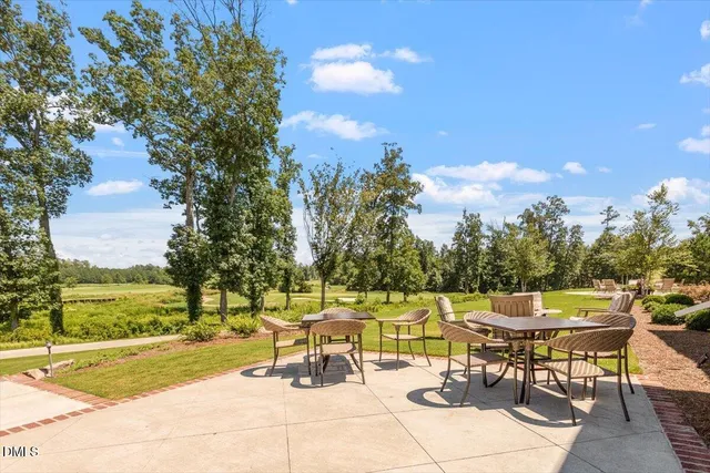 a view of swimming pool with furniture and city view
