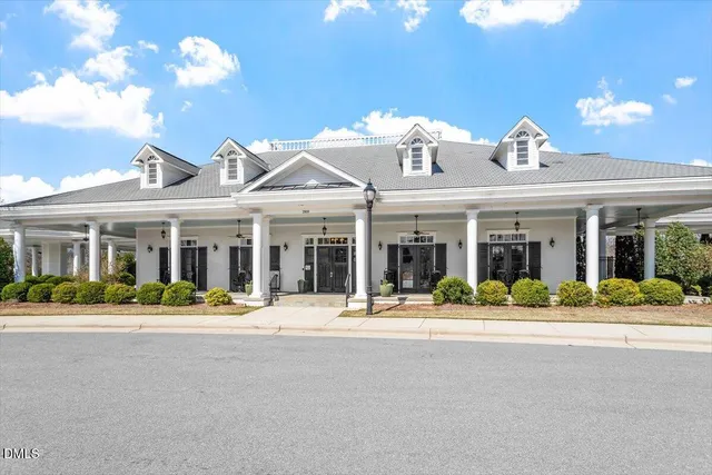 a view of a house with swimming pool and sitting area