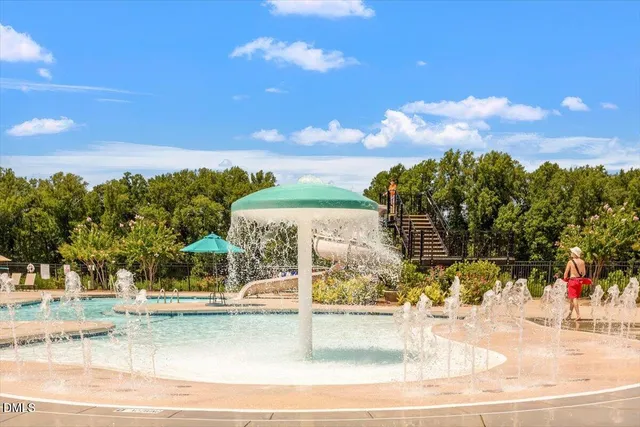 a view of a patio with a dining table and chairs under an umbrella