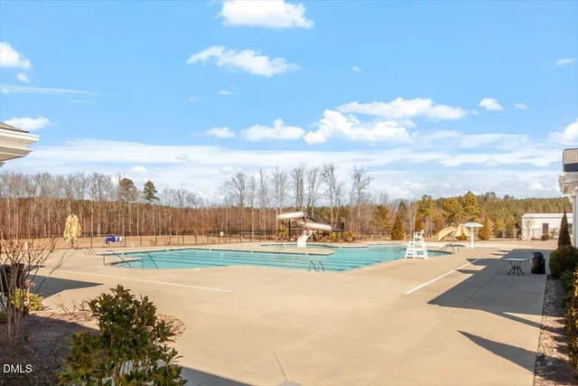 a view of a swimming pool with an outdoor seating and a yard