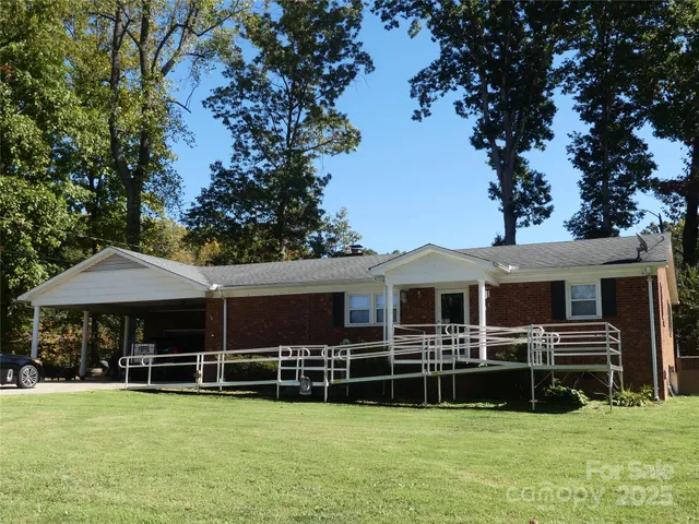 a view of a house with a large window and a yard