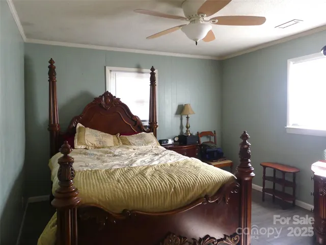 a bed sitting in a bedroom next to a window