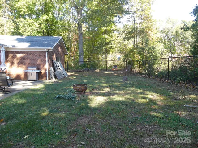 a view of a yard with large trees