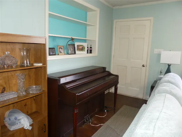 a living room with a couch and a potted plant on the wall