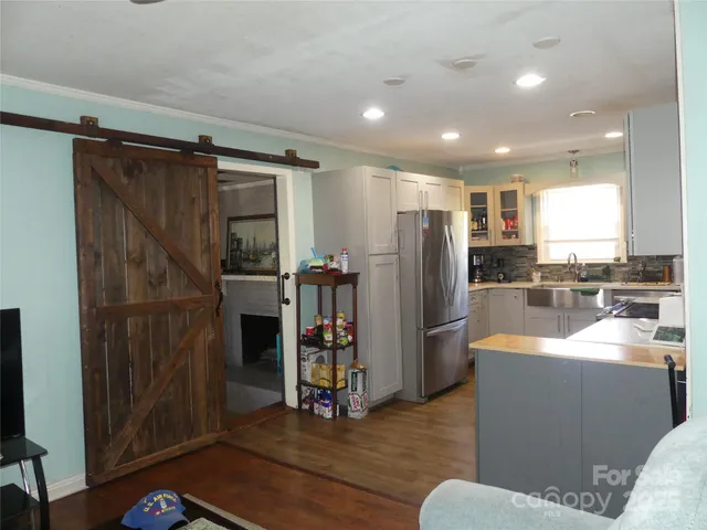 a kitchen with stainless steel appliances granite countertop a refrigerator and a sink