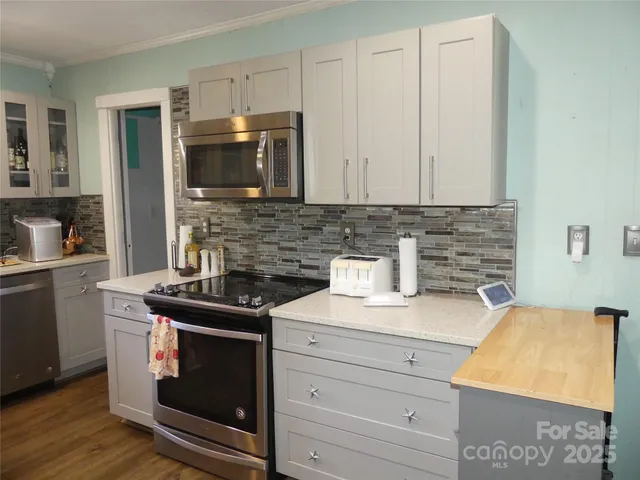 a kitchen with a stove and a microwave