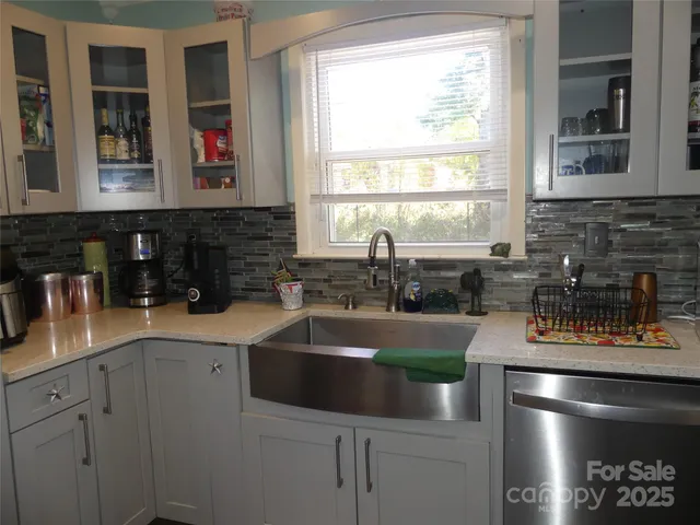 a kitchen with a sink and white cabinets