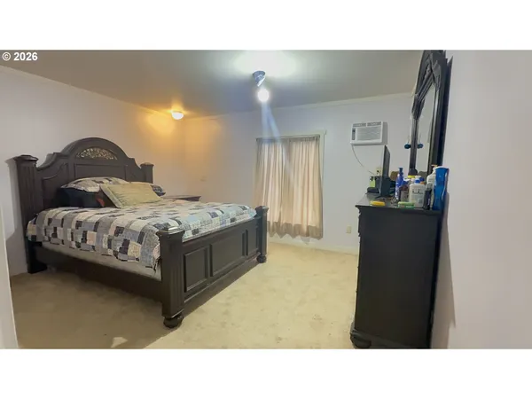 a bedroom with a bed and a dresser