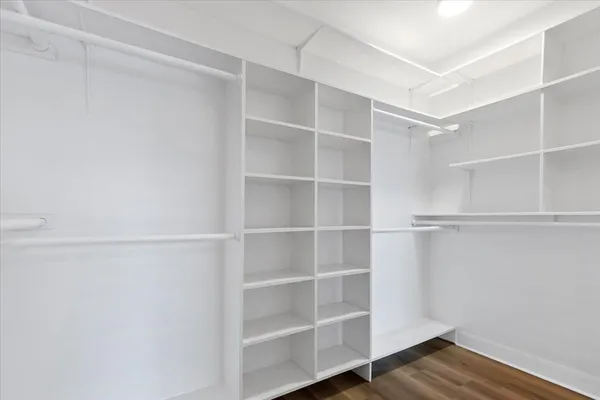 a view of walk in closet with empty racks