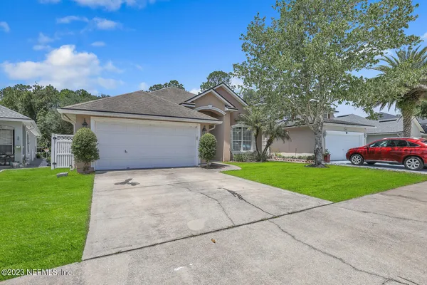 a front view of house with yard and green space