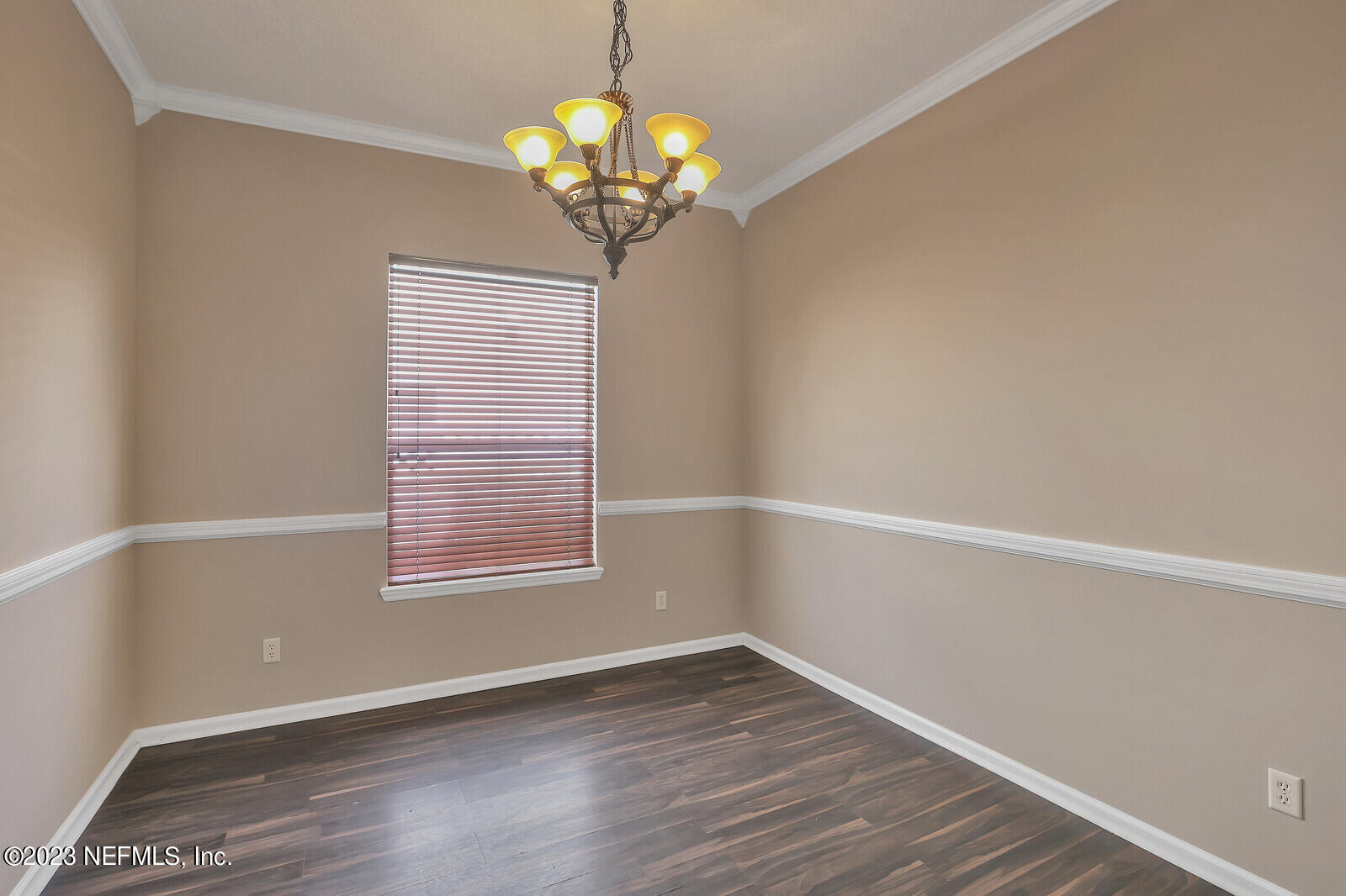 860 Briarcreek Road Jacksonville, FL 32225 - Photo 11 of 24 a view of an empty room with wooden floor and a window