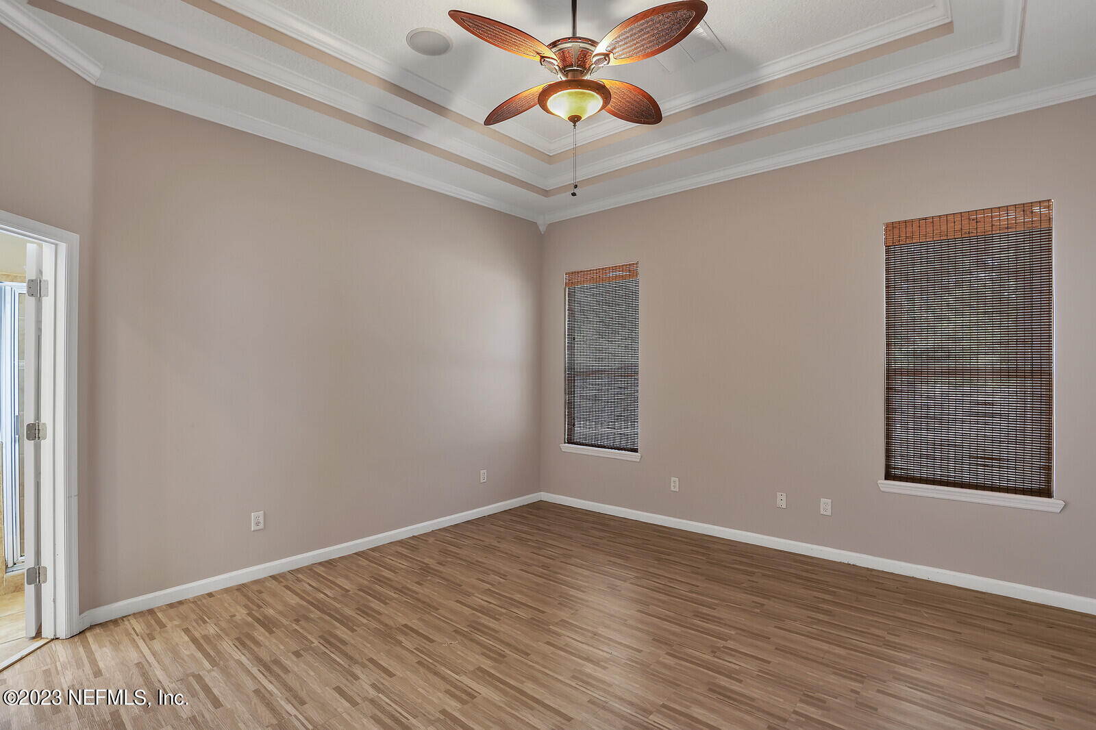860 Briarcreek Road Jacksonville, FL 32225 - Photo 12 of 24 wooden floor in an empty room with a window