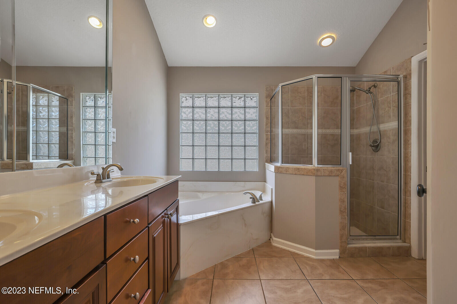 860 Briarcreek Road Jacksonville, FL 32225 - Photo 13 of 24 a bathroom with a tub sink and mirror