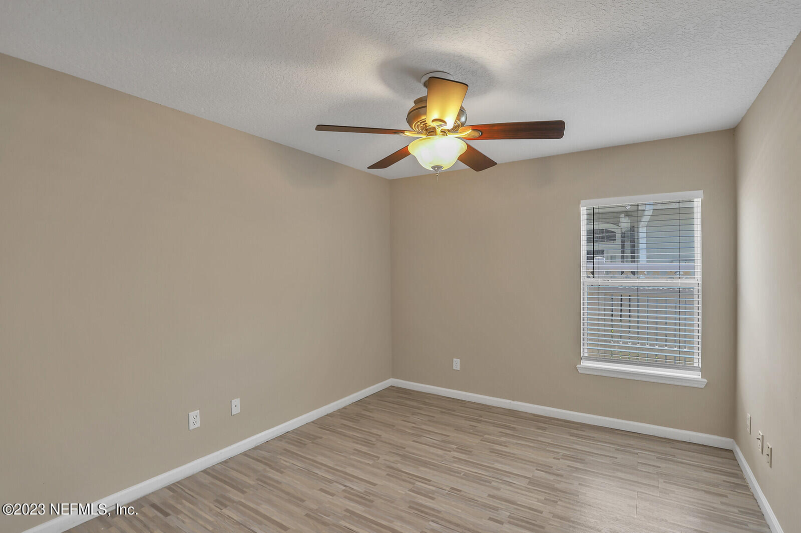 860 Briarcreek Road Jacksonville, FL 32225 - Photo 17 of 24 a view of an empty room with a window and wooden floor