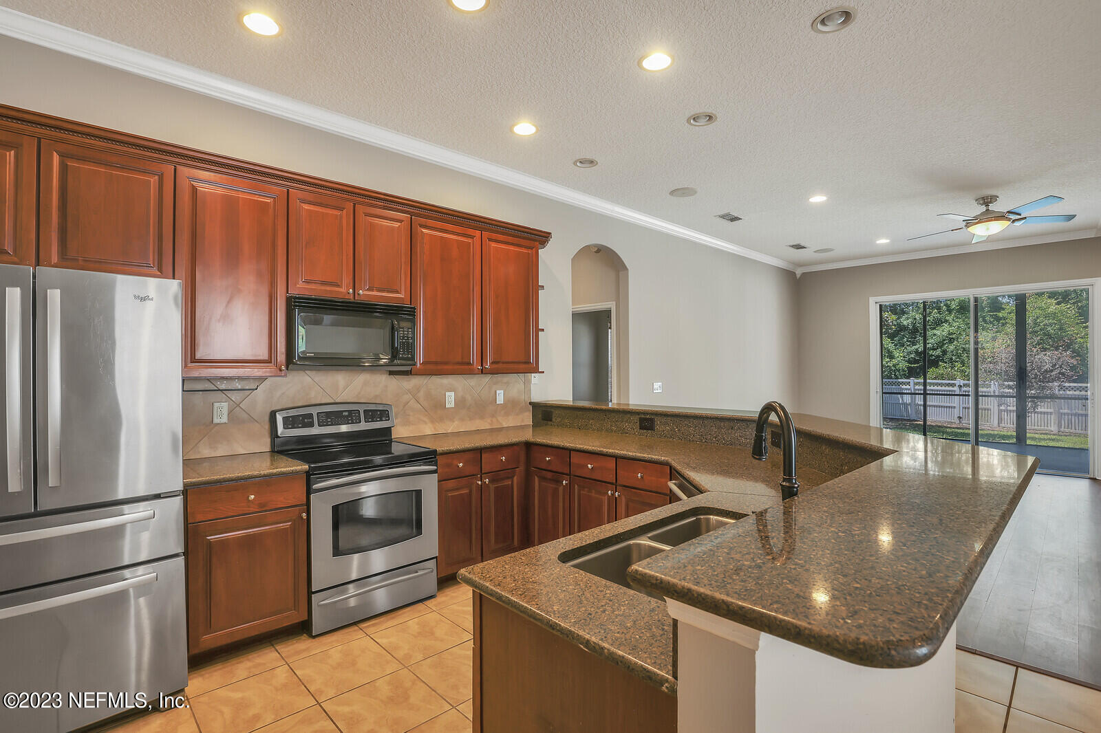 860 Briarcreek Road Jacksonville, FL 32225 - Photo 3 of 24 a kitchen that has a sink and a stove top oven with wooden floor