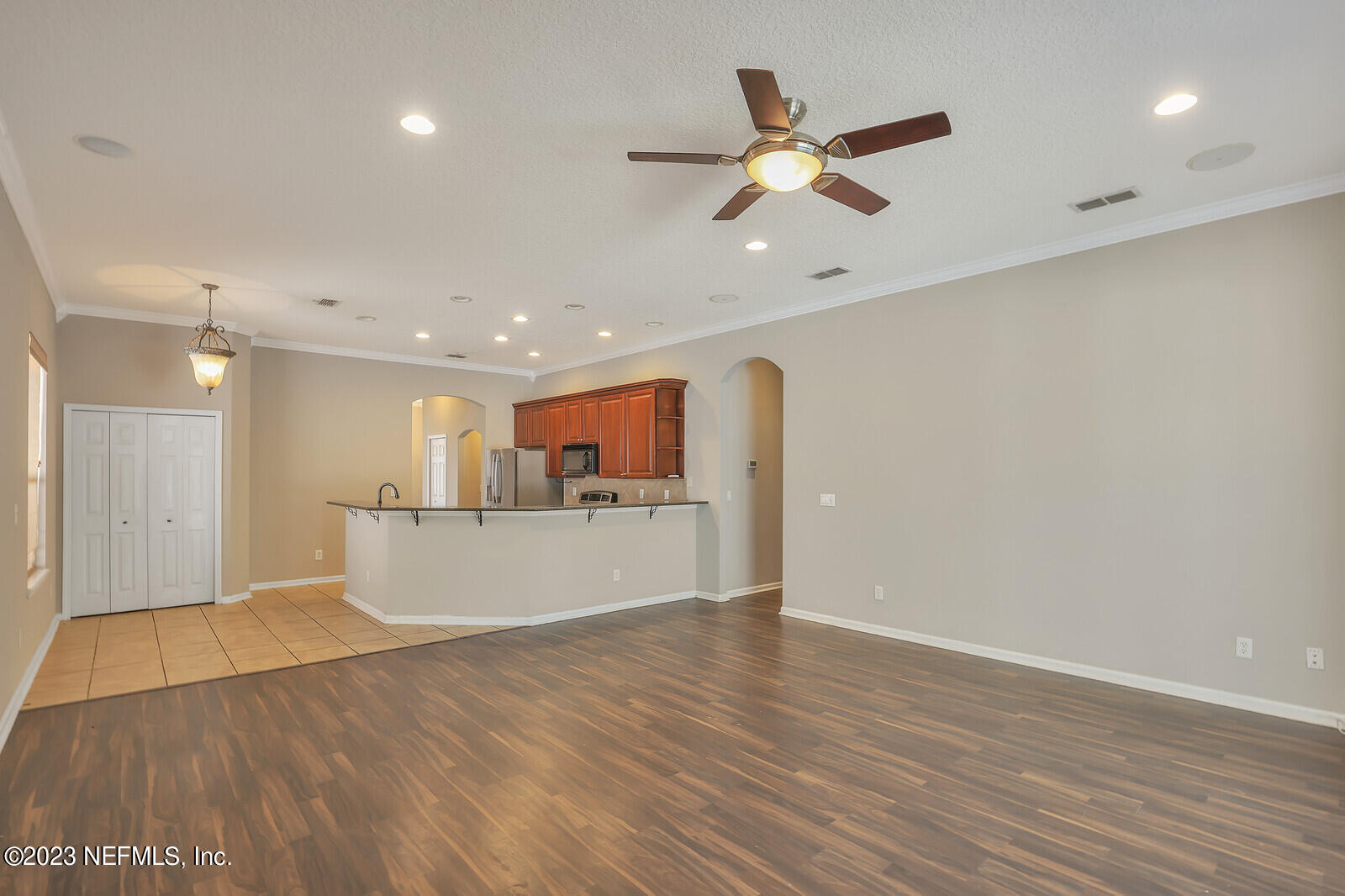 860 Briarcreek Road Jacksonville, FL 32225 - Photo 8 of 24 a view of a livingroom with a ceiling fan wooden floor and a ceiling fan