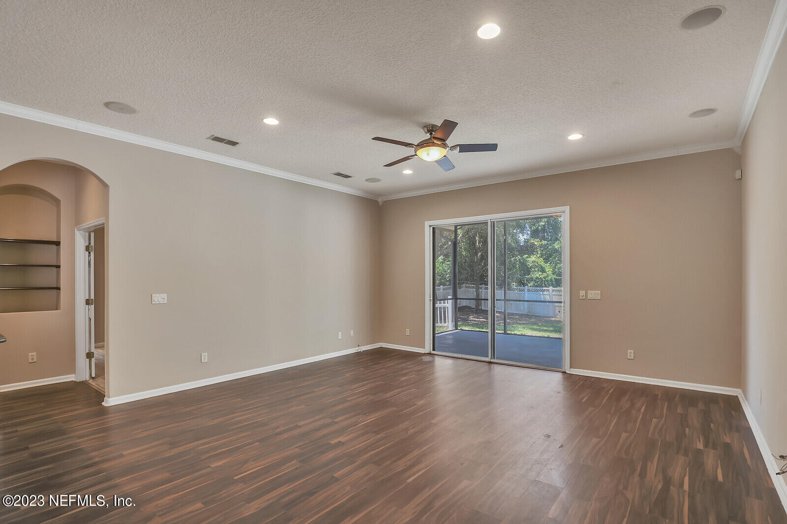 860 Briarcreek Road Jacksonville, FL 32225 - Photo 10 of 24 a view of an empty room with wooden floor and a window