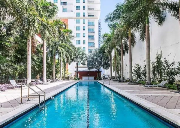 a view of a swimming pool with a chair and tables