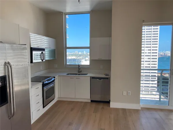 a kitchen with stainless steel appliances a refrigerator sink and stove