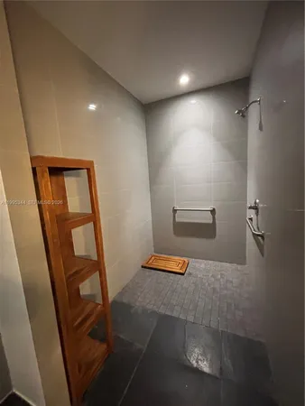 a room with pool table and a view of bathroom