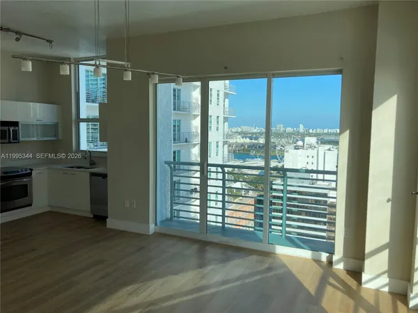 a view of a kitchen with a sink and a window